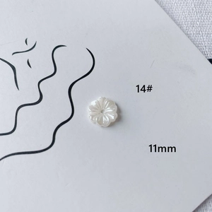 Macro shot of 11mm white acrylic flower bead for DIY jewelry making with central hole