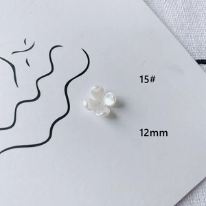 Close-up of 12mm white acrylic flower bead with pearl finish for DIY jewelry crafts