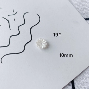 Detail shot of 10mm white acrylic daisy beads for DIY jewelry making and crafts