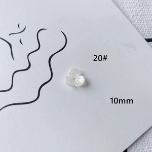 Detail of 10mm white acrylic flower bead with pearl finish for DIY jewelry making