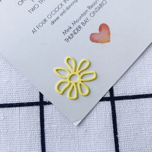 Macro shot of yellow hollow flower charm accessory with matte finish for DIY jewelry crafts