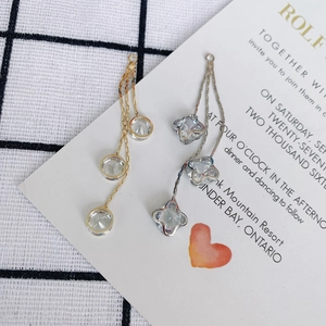 Exquisite gold round and silver clover crystal star earrings on elegant white stationery