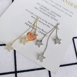 Star tassel drop earrings with sparkling crystals in gold and silver finish