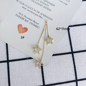Detailed view of triple star gold tassel earring pendant with zircons, size 62x11mm