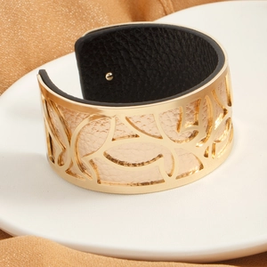 Golden hollow leaf wide cuff bracelet with reversible champagne and black leather insert