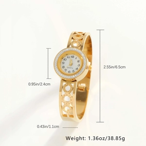 Macro detail of gold bangle watch featuring a zircon bezel and cutout ring strap