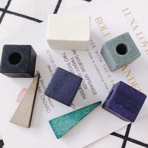 DIY geometric wooden beads in square and triangle shapes for jewelry making on artistic cloth