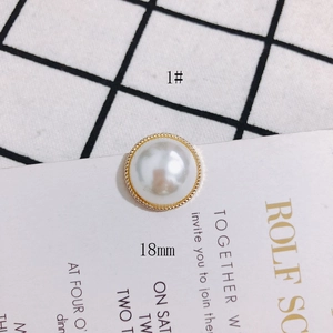 Detail view of 18mm round pearl button earring component with gold twisted metal border