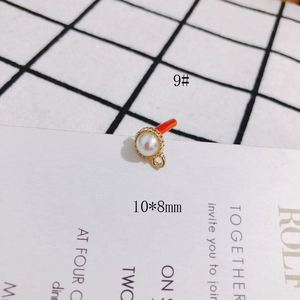 Detailed view of 10x8mm faux pearl pendant connector in gold scalloped setting