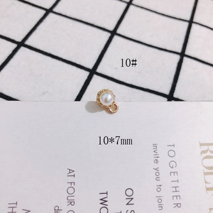 Macro view of a 10x7mm S925 silver pearl pendant with golden floral metal edging detail