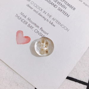 Detail shot of a faceted transparent resin cabochon with dried flowers for DIY jewelry