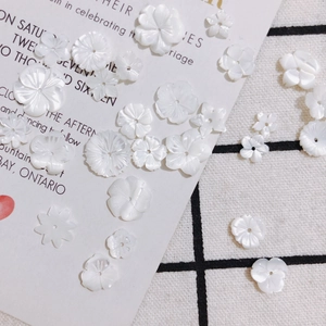 Pearlescent white shell flower charms with center holes for DIY jewelry making and crafts