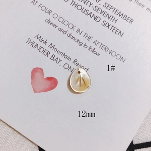 Macro view of a 12mm teardrop-shaped natural shell charm with radial texture for jewelry DIY