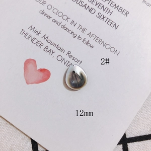 Macro shot of 12mm teardrop-shaped shell pendant with iridescent mother-of-pearl texture