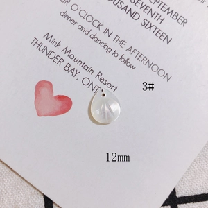 Detail of a 12mm leaf-shaped white mother of pearl pendant with radial texture