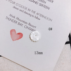 Detail of 13mm white shell flower bead with carved petal texture for DIY jewelry making