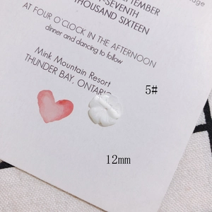 Macro detail of 12mm white shell flower bead with 5-petal carving for DIY jewelry