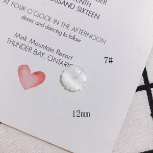 Detail of 12mm white carved shell flower bead for DIY jewelry making with central hole