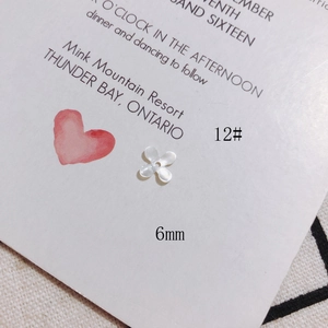 Detailed macro view of a 6mm white shell flower petal accessory for DIY jewelry making