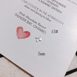 Detailed macro view of a 5mm white shell flower petal bead for DIY jewelry making
