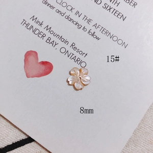 Detailed macro of 8mm five-petal white mop shell flower bead for DIY jewelry making