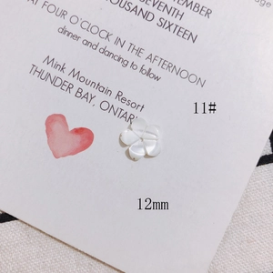 Macro view of 12mm white shell flower bead for DIY jewelry and hair accessories