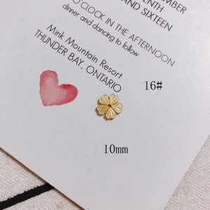 Detailed macro view of 10mm yellow shell cherry blossom charms for DIY jewelry making