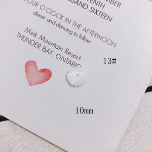 Detailed macro view of a 10mm white mother of pearl flower bead for DIY jewelry making