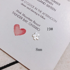 Detail of 8mm white shell flower bead with iridescent luster for DIY jewelry making