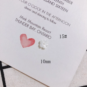 Macro shot of 10mm white shell flower bead for DIY jewelry making and hair pins