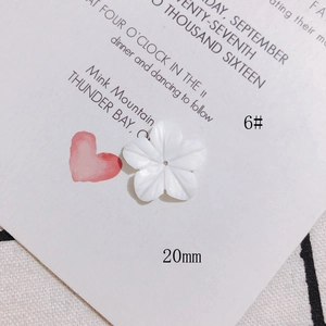 Détail macro d'une fleur de nacre sculptée blanche à cinq pétales pour bijoux DIY