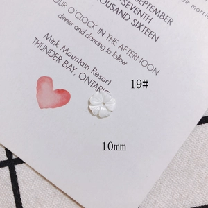 Macro detail of 10mm white carved shell flower bead for jewelry making projects