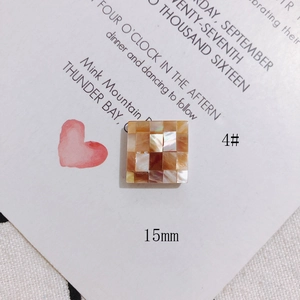 Macro detail of 15mm square shell mosaic jewelry accessory with natural pearl luster
