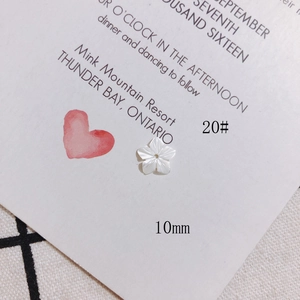 Macro view of 10mm white shell flower bead with carved texture for DIY jewelry making