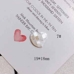 Macro detail of a 19x18mm heart-shaped mother of pearl shell mosaic jewelry accessory