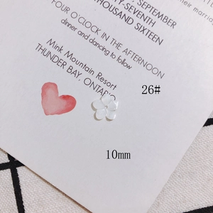 Macro detail of 10mm white shell-textured flower bead for DIY jewelry making
