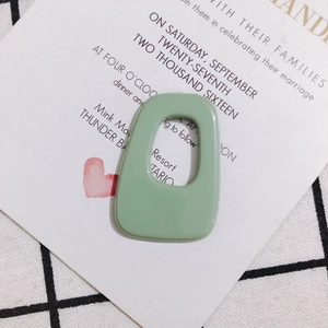 Macro shot of mint green irregular acrylic pendant for DIY jewelry and earrings