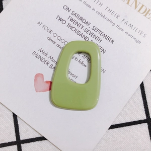 Macro view of avocado green irregular rectangular acrylic pendant for DIY jewelry
