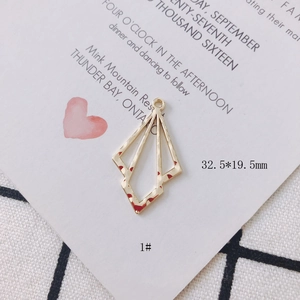 Close-up of golden irregular geometric hollow pendant with hammered metal texture