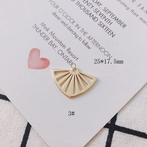 Macro shot of 25x17.5mm gold hollow fan-shaped metal pendant charm for DIY jewelry