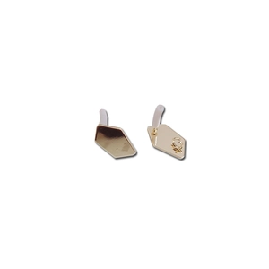 Detailed macro view of golden irregular geometric earring studs with silicone backing plugs
