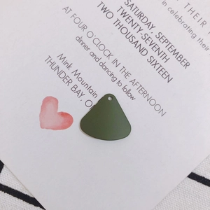 Macro detail of dark green fan-shaped alloy charms for DIY handmade jewelry crafts
