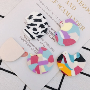 Artistic fan-shaped polymer clay earring pendants with colorful abstract patterns