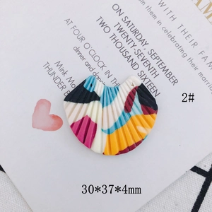 Detail of fan-shaped resin earring charm with colorful abstract oil painting effect