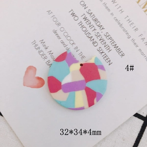 Detail of colorful fan-shaped clay earring charms with dimensions of 32x34x4mm