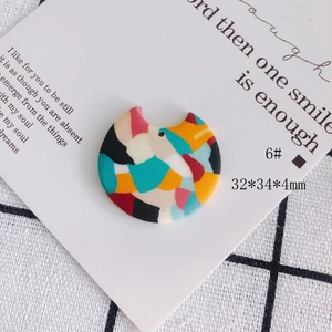 Detailed macro of colorful abstract fan-shaped geometric earring charms in 32x34mm size