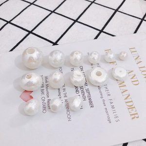 Irregular DIY pearl beads with pearlescent finish on decorative cards and checkered cloth