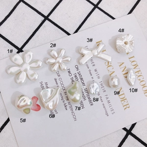 Set of 10 pearl white DIY jewelry charms in flower and bow shapes for handmade crafts