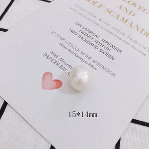 Detail view of 15x14mm baroque pearl bead with iridescent luster on a greeting card