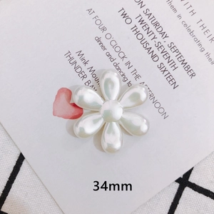 Close-up of a 34mm white pearl luster flower charm for DIY handmade jewelry and hair accessories